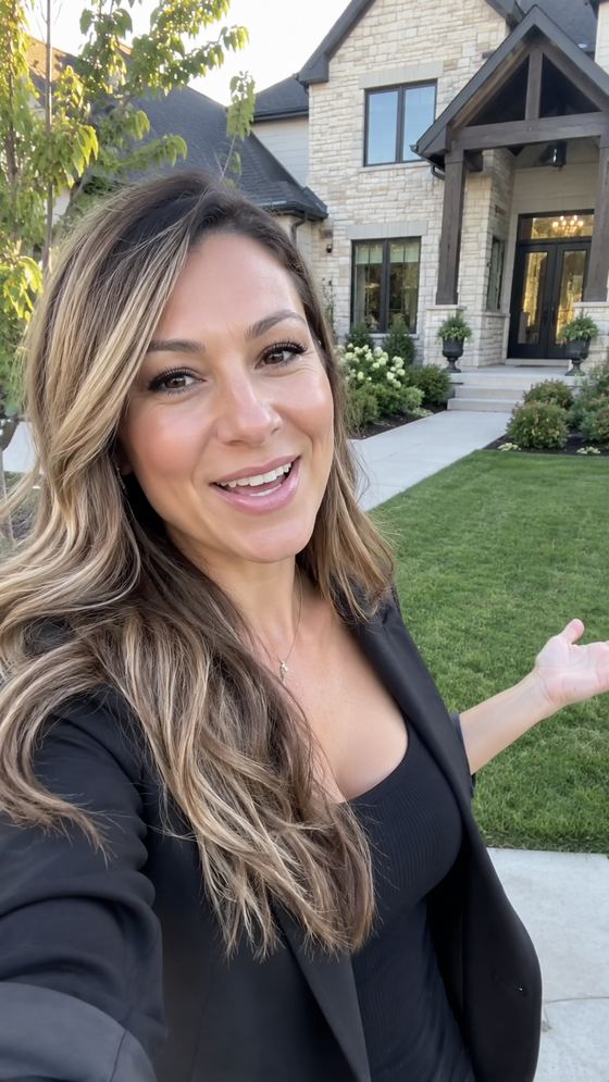 Raw, unedited phone video frame of a real estate agent giving a market update in front of a listing.